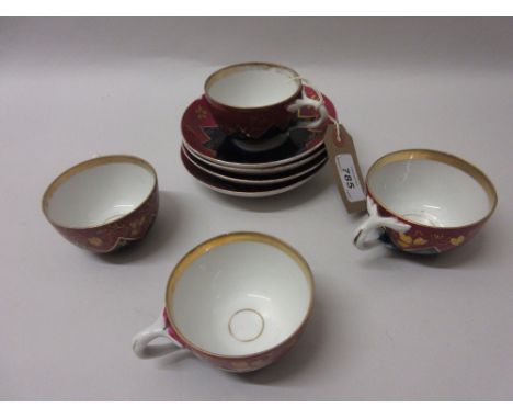 Set of four early 20th Century Russian porcelain cabinet cups and saucers decorated in blue, cerise and gilt