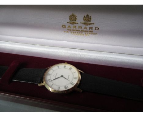 Gentleman's 9ct gold cased wristwatch by Garrard, the enamel dial with Roman numerals on a leather strap with original box et