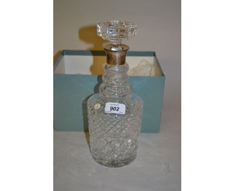 Cut glass silver collared decanter with stopper in original box