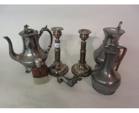 Pair of silver plated on copper candlesticks, plated hot water pot, two pewter jugs, pewter dog and a hip flask