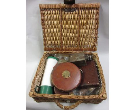 Wicker hamper with flask and cutlery, two leather and brass tapes, another later tape and a brass instrument in box