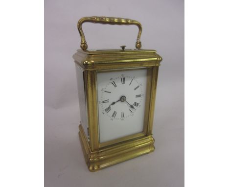 19th Century French gilt brass cased carriage clock, the gorge case enclosing an enamel dial with Arabic and Roman numerals, 