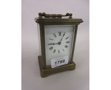 Small brass cased carriage clock with enamel dial and Roman numerals