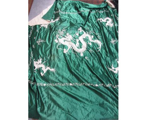 Large Chinese green silk panel with detailed embroidery of a large central dragon with four smaller dragons with a scroll for