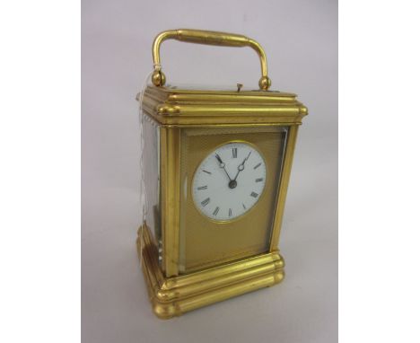 19th Century French gilt brass cased carriage clock, the gorge case enclosing an engine turned dial surround, the circular en
