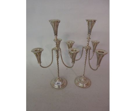 Pair of 20th Century silver plated four light candelabra with barley twist arms and supports on circular gadroon bases