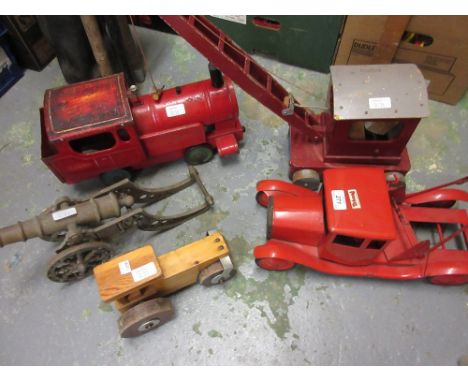 Triang tin plate toy tow truck, a wooden toy steam roller and crane, tin plate railway locomotive and a brass model canon