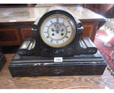 Late 19th Century French black slate and green flecked marble mantel clock, the enamel dial with Roman numerals, the two trai