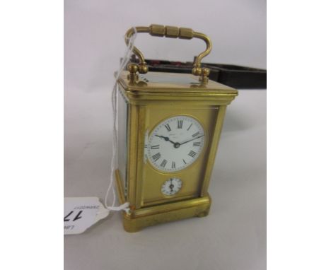 Miniature matt gilt brass cased carriage clock with a circular enamel dial and Roman numerals, signed Henry Capt Geneva, sign