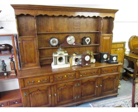 Good quality reproduction fruitwood dresser in 18th Century style, the boarded shelf and cupboard back above four drawers and