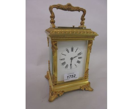 Ornate 19th Century gilt brass cased carriage clock with acanthus leaf mounted and fluted corner pilasters, scroll shaped han