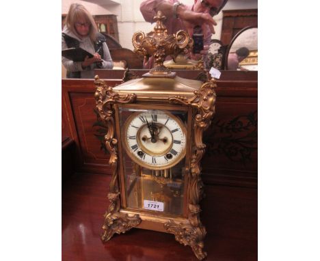 Late 19th Century French four glass library clock, the rococo design ormolu case enclosing an enamel dial with Roman numerals