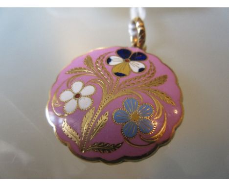 Victorian yellow metal and enamel floral decorated memorial pendant of shaped circular design with hair insert