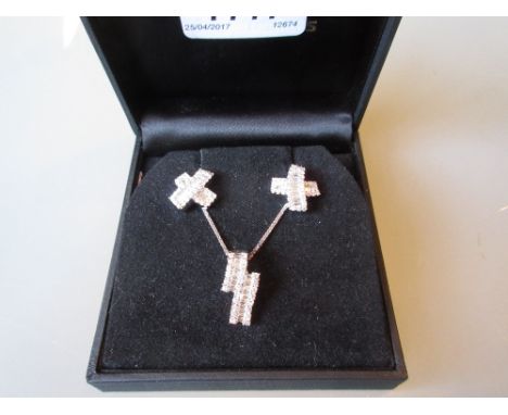 18ct White gold pendant on chain with matching ear studs set with baguette and round brilliant cut diamonds
