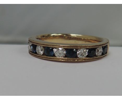 A ladies half eternity ring having sapphire and diamonds in a channel setting on a 9ct gold loop