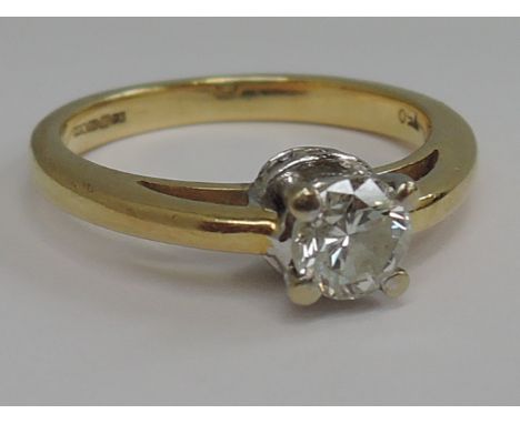 A ladies diamond solitaire ring, approx .45ct in a raised square claw set mount with diamond chip collarette on an 18ct gold 