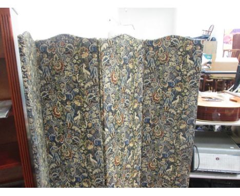 An early 20th century four division screen having foliate tapestry upholstery