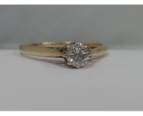 A ladies diamond solitaire ring, approx .25ct in a raised claw setting with shaped shoulders on a 9ct gold loop
