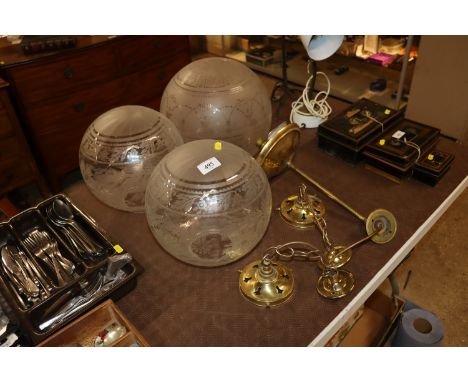 A pair of brass light fittings and another similar with glass shades 