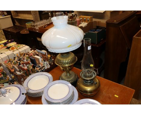 A Defries brass oil lamp with milk glass shade and glass chimney; together with one other brass oil lamp with glass chimney