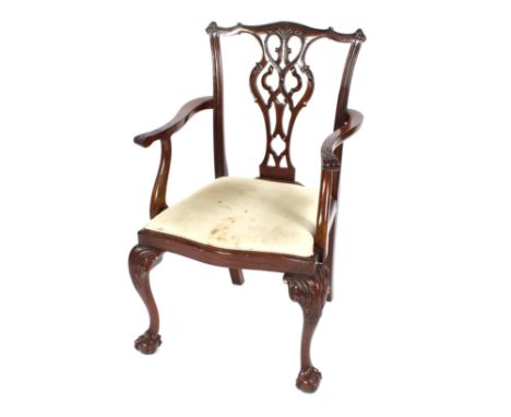 A set of six mahogany Chippendale design dining chairs raised on carved cabriole supports terminating in claw and ball feet, 