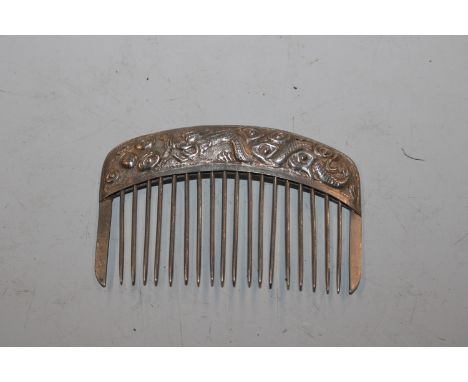 A Chinese white metal hair comb with dragon ornament, marked 