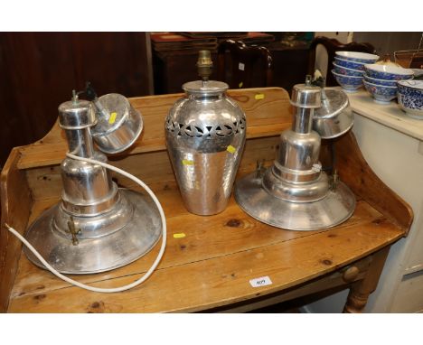 A pair of industrial style light fittings and a similar table lamp