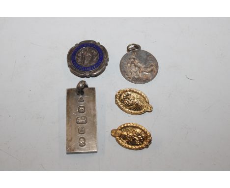 A silver ingot pendant approx. 30gms; two silver gilt badges; a silver and enamel decorated nursing badge; and a white metal 