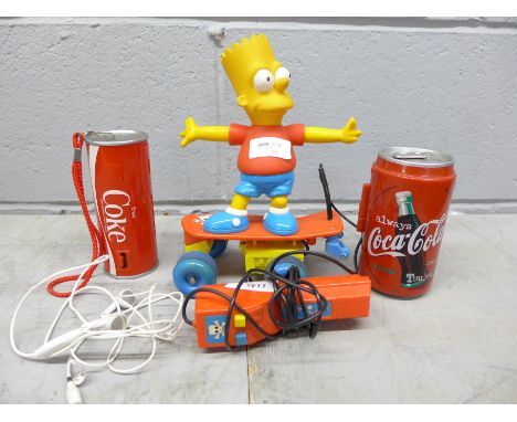 A The Simpsons Bart skateboard toy, a Coke camera and cassette player 