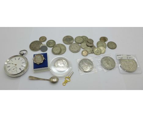 A collection of coins including silver, a silver pocket watch and a silver salt spoon 