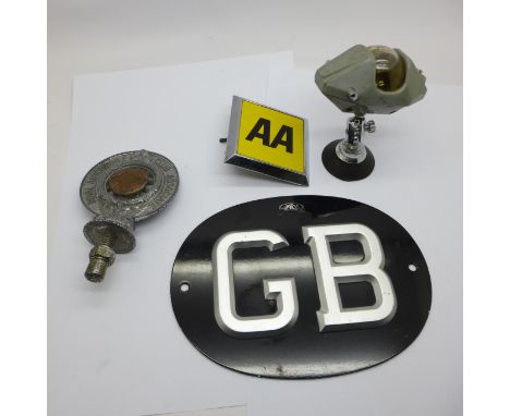 A RAC badge, an AA badge, a GB plaque and a car compass 