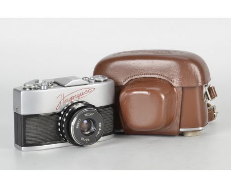 A Krasnogorsk Narciss SLR Camera, chrome, serial no. 6409956, with Vega-M-1 f/2.8 35mm lens, serial no. 6677, body, VG, shutt