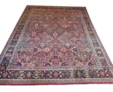 ANTIQUE ZIEGLER MAHAL CARPET, 416cm x 314cm, all over design of palmettes, flowerheads and vines framed by a corresponding mi