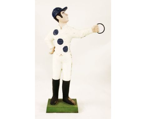 A cast iron and later painted lawn tethering post, early 20th century, in the form of a jockey in blue and white silks, with 