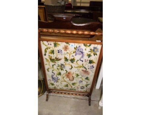 An early 20th century firescreen, with finely embroidered crewelwork banner