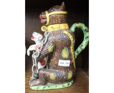 A pottery teapot modelled in the form of a Bear baiting group, inscribed "Bears Grease" in the style of a 19th century Staffo