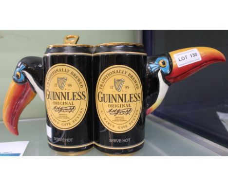 A "Totally Teapots" ceramic teapot, modelled as two cans (Toucans) of Guinnless, written to the base "Trial Piece, Dec 2002"