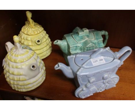 Two Crinoline lady pottery teapots, together with a Cinderella teapot, glazed blue and a green cottage teapot (4)