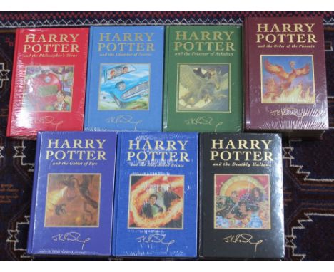 Harry Potter J.K.Rowling A Complete set of the de-luxe editions the 7 volumes are all in shrink wrapped unopened condition so