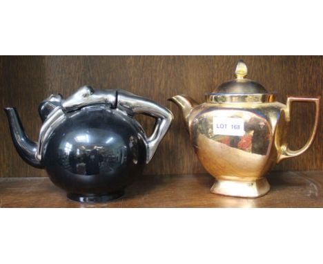 An Art Deco design ceramic teapot, having silver lustre lady draped over the top, together with a gilded teapot (2)