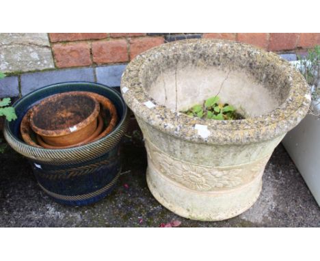 A cast garden planter with floral decorated band