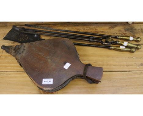 A set of brass handled cast iron fireside tools, together with a set of bellows