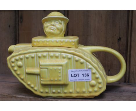 A "Sadler" pottery teapot modelled as a First World War tank, with "Old Bill" type character lid knop, yellow glazed