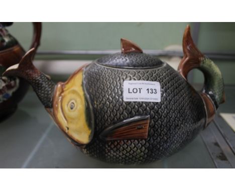 A late 19th century teapot modelled as a fish, consuming a smaller fish Condition: some crazing all over, particularly notice