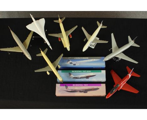 A collection of seven plastic scale model aircraft, including Boeing 767 and Concorde, three with original boxes. H.29 W.24cm