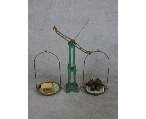 A set of early/mid 20th century painted cast iron balance scales complete with weights. H.96 W.89 D.29cm 