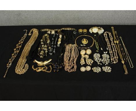 A large collection of mixed costume jewellery, including a fashion watch with faux pearl tassel design strap, a pair of tulip