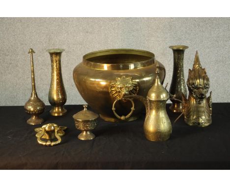 An assortment of mixed brass ware to include a pair of Indian vases, a jardinière&nbsp;with twin lion mask swing handles, doo