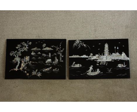 A 20th century pair of Chinese lacquered and mother of pearl inset rectangular wall plaques depicting river and farming scene