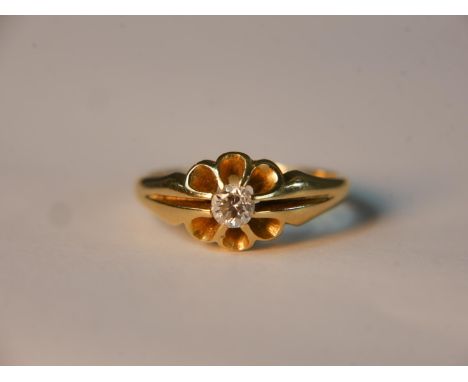 A yellow metal (tests as 18ct) diamond set floral design carved ring. Set to centre with a round old cut diamond in a fancy c